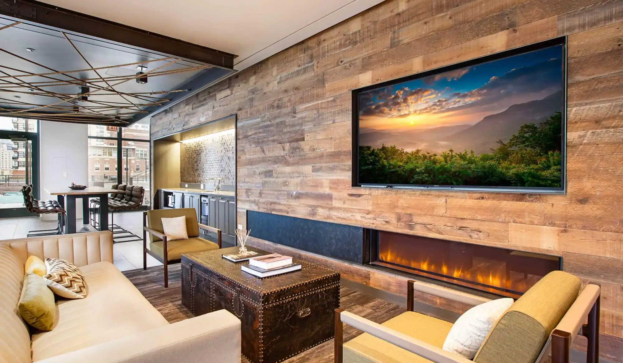 Resident lounge with large TV and fireplace at Exhibit On Superior in Chicago, Illinois